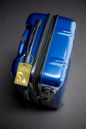 Delta Air Lines: The winner's package: a TUMI suitcase, a trophy, a brass luggage tag, a handwritten note. (2 of 3)